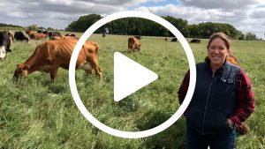 Video play button featuring Carrie Redden's farm